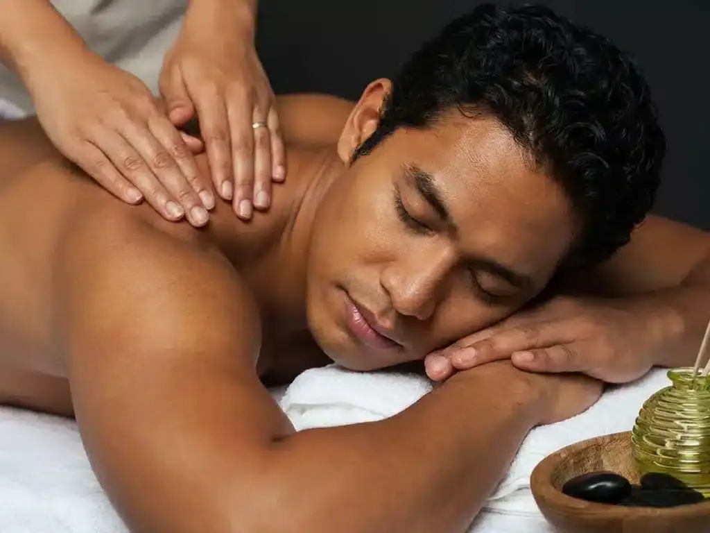 Man receiving a soothing massage for relaxation at Healers Touch Spa.